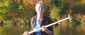 Portrait of Liz Engleman holding a boat paddle.